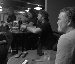 Expeditioner in foreground watching the darts tournament