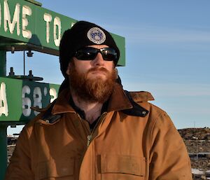 Expeditioner standing in front of the Davis signpost