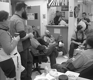 Expeditioners gathered in an office for after work drinks