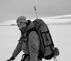 Expeditioner walking in profile looking back over his shoulder