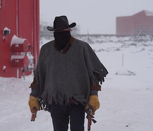 Expeditioner carrying fake firearms wearing a western hat and a sombrero.