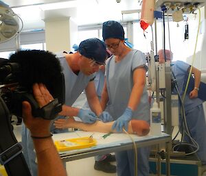 Expeditioner in surgical scrubs during a pre-departure hospital training exercise.