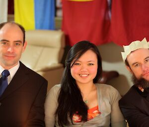 Three expeditioners dressed in formal attire at a previous midwinter celebration.