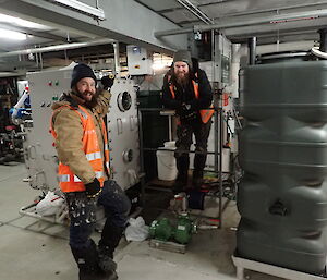 Expeditioners pleased to be inside with the grease trap and storage tank.