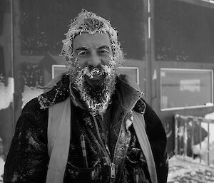 Expeditioner with snow and ice in his hair and beard, after shovelling snow.