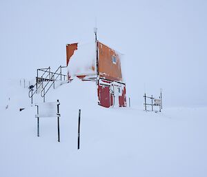 View of two converted 20 foot containers under heavy snow.