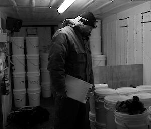 Expeditioner holding a clipboard, counting stores.