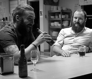 Two expeditioners relaxing at a table.