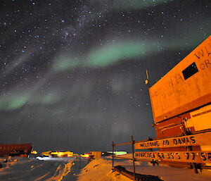 Green auroras in the night sky above the station.