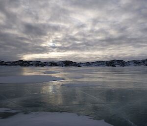 Frozen lake beneath a clouded sky