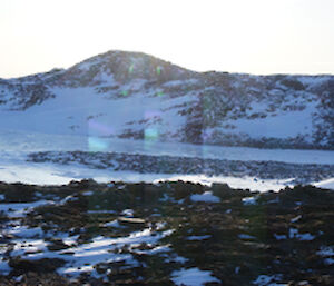 Panoramic shot of frozen fjordland and snow covered hills