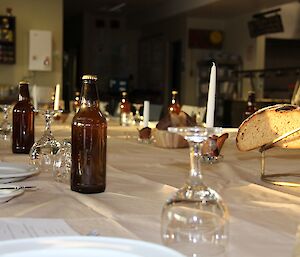 Bottles of mead and homemade bread arranged on a long dining table