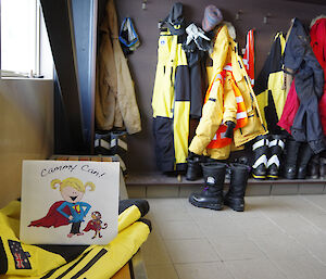 Illustration propped up upon cold weather clothes in the cold porch section of the living quarters