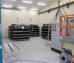 Equipment components positioned in the rear corner of a large storage space
