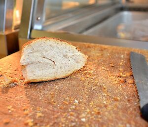 Almost finished piece of bread on a cutting board