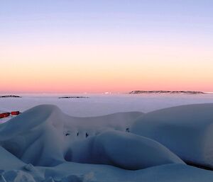 Snow piled high on balcony. sea ice in background