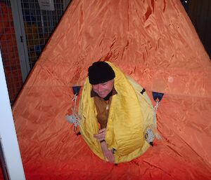 Expeditioner poking his head through a polar pyramid tent