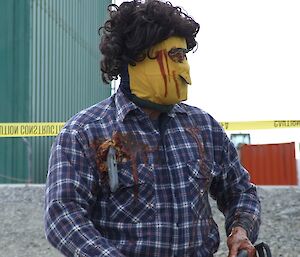 Expeditioner standing in fancy dress costume with fake blood on a checked jacket