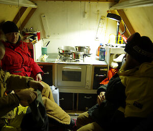 Expeditioners huddled inside a shelter