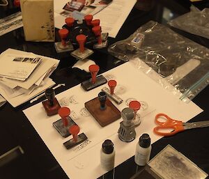 Table covered in stamps and envelopes and other stationary items