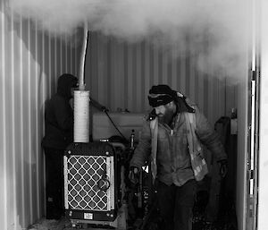 Expeditioner standing beneath smoke emitted from a diesel pump in background