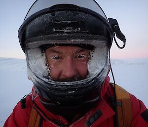 Expeditioner in a helmet covered in frost