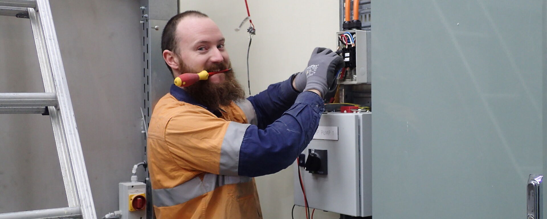 Expeditioner facing camera with screwdriver in his mouth