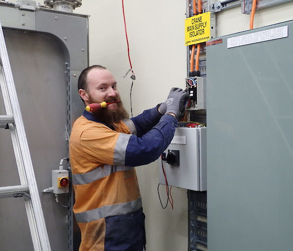 Expeditioner facing camera with screwdriver in his mouth