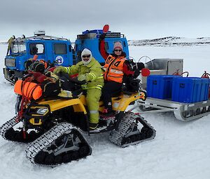 Two expeditioners on the back of a tracked quad vehicle in emergency response kit