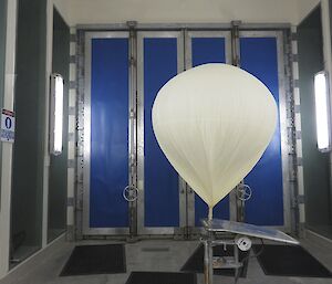 Expeditioner filling a hydrogen balloon within the confines of the balloon release area