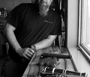 Expeditioner standing beside a number of his craft projects