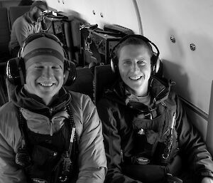 Two expeditioners seated next to each other in a transport aircraft