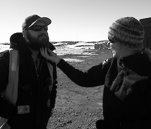 Expeditioner stroking another expeditioners beard