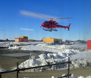 Red helicopter landing at Davis