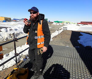 Expeditioner staring at camera chewing on an apple