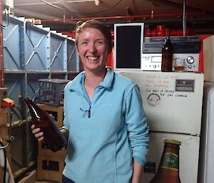 A female expeditioner holding an empty beer bottle