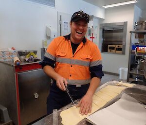 An expeditioner preparing some pastry for cooking