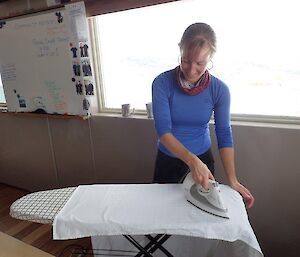 A female expeditioner ironing table cloths