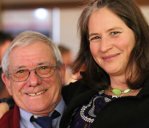 Two expeditioners posing for a photo at the dinner table