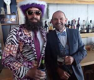 Two male expeditioners dressed in suits for dinner