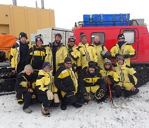 twelve scientists pose for a photograph in front of a haggland vehicle