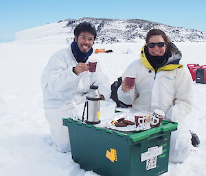 Two expeditioners enjoying a hot brunch on the sea ice
