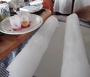 two ice cores laying on a table.