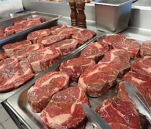 A plate of steaks ready to be cooked