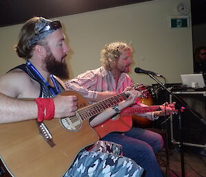 Two expeditioners singing a song on stage