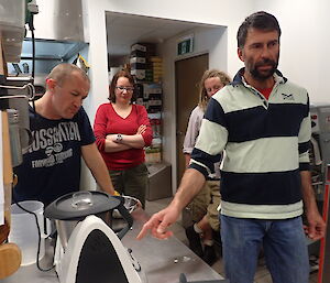 Two expeditioners examining a Thermomix machine