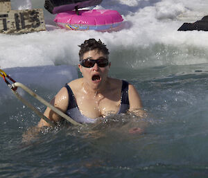 A shocked expression on an expeditioners face when she hit the cold water in the summer swim