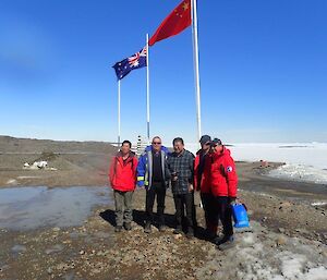 Chinese visitors to Davis pose for a photo with the Davis Station Leader