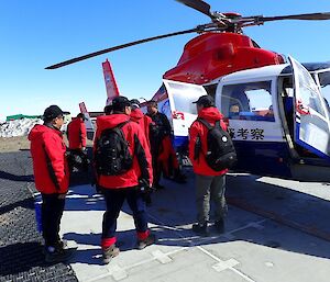 A group of Chinese expeditioners entering a helicopter