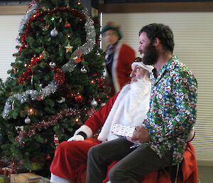 An expeditioner sitting on Santa’s knee
